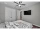 Comfortable bedroom with a ceiling fan, TV, and large closet for ample storage at 8816 Mugnai St, Riverview, FL 33578