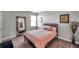 Cozy bedroom has a large mirror and is decorated with lovely art at 8816 Mugnai St, Riverview, FL 33578