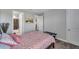 Bright bedroom with soft carpet, neutral walls, and patterned bedding for a cozy retreat at 8816 Mugnai St, Riverview, FL 33578