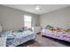 Bright ' bedroom featuring two beds and a ceiling fan at 8816 Mugnai St, Riverview, FL 33578
