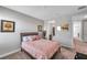 Cozy bedroom featuring wood-framed bed with patterned bedding, neutral walls, and carpet flooring at 8816 Mugnai St, Riverview, FL 33578
