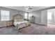 Elegant bedroom featuring a large bed, matching dressers, and natural light at 8816 Mugnai St, Riverview, FL 33578