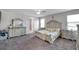 Elegant bedroom featuring a large bed frame, dresser, and carpeted floors at 8816 Mugnai St, Riverview, FL 33578