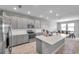 Well-lit kitchen with stainless steel appliances, a large island, and gray cabinetry at 8816 Mugnai St, Riverview, FL 33578