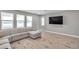 Bright living room with tiled floors and a comfortable sectional couch at 8816 Mugnai St, Riverview, FL 33578