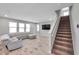 Spacious living room with gray sectional sofa and staircase at 8816 Mugnai St, Riverview, FL 33578