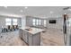 Open-concept kitchen and dining area with modern appliances and a large island at 8816 Mugnai St, Riverview, FL 33578