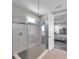 Spa-like shower with gray tiling, glass surround, and entry into the main bedroom at 8816 Mugnai St, Riverview, FL 33578
