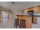 The kitchen features a central island with seating and wood cabinetry and appliances at 96 New York Avenue, Dunedin, FL 34698