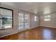 Bright living room with wood floors, multiple windows and french doors at 96 New York Avenue, Dunedin, FL 34698