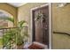 A welcoming front entrance with a charming wreath and decorative potted plant and doormat at 10115 Courtney Palms Blvd # 202, Tampa, FL 33619