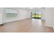 Spacious living room featuring a glass sliding door with backyard views and access at 10344 Cross River Trl, Parrish, FL 34219