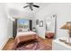 Cozy bedroom with a ceiling fan, natural light, and wooden floors with area rug at 1051 Point Seaside, Crystal Beach, FL 34681