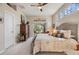 Bright main bedroom features a ceiling fan and sliding glass doors to the outdoor patio at 1200 Country Trails Dr, Safety Harbor, FL 34695