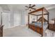 Bedroom with a four poster bed and carpet floors at 1238 E Kennedy Blvd # 704, Tampa, FL 33602