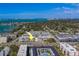 Aerial view of the building near the water and local areas at 131 Bluff View Dr # 208, Belleair Bluffs, FL 33770
