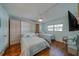 Comfortable bedroom with hardwood floors, two beds and ceiling fan at 131 Bluff View Dr # 208, Belleair Bluffs, FL 33770