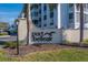 Elegant 'Port Belleair' community sign surrounded by lush landscaping and a well-maintained exterior at 131 Bluff View Dr # 208, Belleair Bluffs, FL 33770