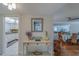 Console table in entryway with fresh flowers and view into kitchen and dining areas at 131 Bluff View Dr # 208, Belleair Bluffs, FL 33770