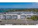 Wide view of condo building highlighting the exterior architecture, design, and landscaping along a busy street at 131 Bluff View Dr # 208, Belleair Bluffs, FL 33770
