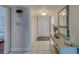Inviting tiled hallway features charming decor and leads to living spaces at 131 Bluff View Dr # 208, Belleair Bluffs, FL 33770
