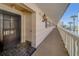 Condo entryway showcasing the exterior corridor, unit door, lighting fixtures, and waterfront view at 131 Bluff View Dr # 208, Belleair Bluffs, FL 33770