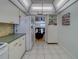 Tile floor in kitchen leading to a view of the living room at 131 Bluff View Dr # 208, Belleair Bluffs, FL 33770