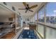 Bright sunroom showcasing large windows, a ceiling fan, sliding glass doors and a neutral color palette for a relaxing atmosphere at 131 Bluff View Dr # 208, Belleair Bluffs, FL 33770