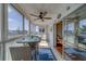 Enclosed sunroom bathed in natural light, featuring a ceiling fan and tile flooring that connects to the rest of the house at 131 Bluff View Dr # 208, Belleair Bluffs, FL 33770