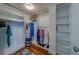 Spacious walk-in closet with custom shelving, hanging rods and hardwood floors; ideal for organizing your wardrobe and accessories at 131 Bluff View Dr # 208, Belleair Bluffs, FL 33770
