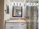 Updated bathroom featuring granite vanity, tile shower with glass door, and decorative lighting at 13112 Groveland St, Spring Hill, FL 34609