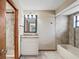 Updated bathroom with granite vanity, tile shower, tub and decorative tile accents at 13112 Groveland St, Spring Hill, FL 34609