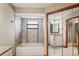 A bright bathroom with updated tile, fixtures, tub, shower, and mirrored door at 13112 Groveland St, Spring Hill, FL 34609