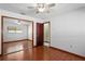 Bright bedroom with hardwood floors, ceiling fan, and sliding closet doors at 13112 Groveland St, Spring Hill, FL 34609