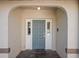 Inviting entryway features a stylish gray front door with sidelights and decorative brick pavers at 13112 Groveland St, Spring Hill, FL 34609