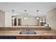Kitchen sink featuring granite countertop and modern lighting fixtures at 13112 Groveland St, Spring Hill, FL 34609