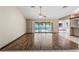 Open living room with hardwood floors and sliding glass doors leading to the pool area at 13112 Groveland St, Spring Hill, FL 34609
