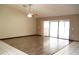 Bright living room with wood-look floors and sliding glass doors to a patio at 13112 Groveland St, Spring Hill, FL 34609