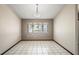 Neutral living room with white tile and a large front window at 13112 Groveland St, Spring Hill, FL 34609