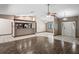 Open-concept living area with a bar overlooking the kitchen with stainless steel appliances at 13112 Groveland St, Spring Hill, FL 34609