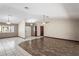 Large living room with tile and wood floors featuring a view to the entryway at 13112 Groveland St, Spring Hill, FL 34609
