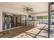 Open patio with brick floor, ceiling fan, outdoor bar, and sliding door access to the living area at 13112 Groveland St, Spring Hill, FL 34609