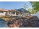 A lovely screened in pool in a backyard with mature landscaping at 13112 Groveland St, Spring Hill, FL 34609