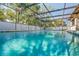 This is an in-ground pool with screened-in enclosure that has ladder for entry/exit at 13112 Groveland St, Spring Hill, FL 34609