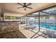 A covered patio featuring a bar and an outdoor pool at 13112 Groveland St, Spring Hill, FL 34609
