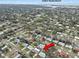 Aerial view showcasing a home with a pool in a tree-lined residential neighborhood near Indian Rocks Beach at 1350 Maple Sw St, Largo, FL 33770