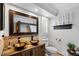 Bathroom boasting double vessel sinks, sleek fixtures, modern vanity, and tile flooring at 1350 Maple Sw St, Largo, FL 33770