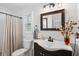 This bathroom features a vanity with a white countertop and a decorative mirror at 1350 Maple Sw St, Largo, FL 33770