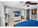 Cozy bedroom with blue quilt, white dresser, ceiling fan, and natural light from the windows at 1350 Maple Sw St, Largo, FL 33770