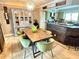Elegant dining area with a rustic wooden table, stylish green chairs, and a vintage cabinet at 1350 Maple Sw St, Largo, FL 33770
